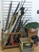A large collection of vintage fishing tackle including bamboo rods, telescopic rods,