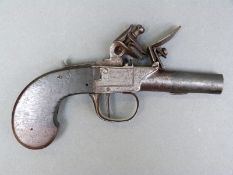 Flintlock hammer action pistol with line engraved lock and trigger guard, thumb slide safety, and 1.