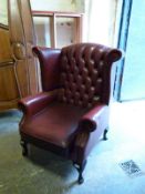 A red Chesterfield wing-back chair