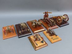 Seven brass and wooden model cannon,