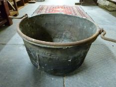 A antique copper cooking pot with iron handle,