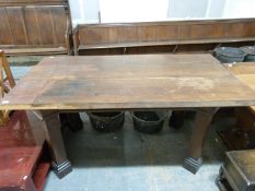 A substantial centre table raised on heavy square legs,