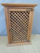 A lattice front pine kitchen or similar cabinet,