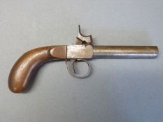 Percussion hammer action pistol with shaped grip and 3.