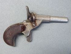 Blank firing .22 hammer action muff pistol with chequered bakelite grips and 2.