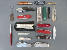 A quantity of folding knives, multi-tools etc to include two military examples, one dated 1945,