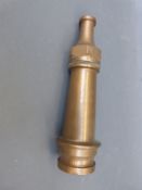 A vintage brass fire hose nozzle,