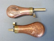 Two copper and brass pistol powder flasks both with embossed decoration of eagles and guns to both