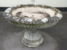 An 18thC carved natural stone large pedestal urn with fluted bowl,