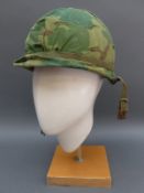 Three modern military helmets and a pair of Cordura boots etc