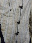 A Victorian ladies mourning jacket with lace collar and decorative lining