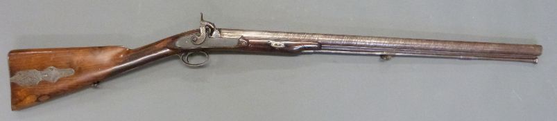 24 bore percussion hammer action gun with engraved hammer, chequered grip, steel butt plate,