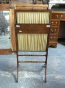 A mahogany and folded silk fire screen with rising slide action and fold down shelf H96 x W44cm