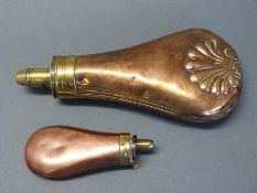 Two copper and brass powder flasks one with embossed shell decoration stamped 'patent', 19.