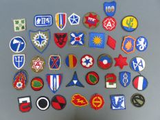 A quantity of WWII US formation cloth badges / insignia