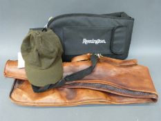 Two gun slips one brown leather the other a modern Remington with side pockets,