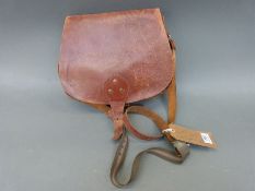 A brown leather cartridge bag with studded decoration and segmented compartments