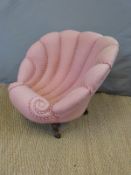 A 19thC upholstered chair in the form of a shell,
