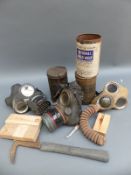 A quantity of gas masks, one dated 5/5/41, escape axe,