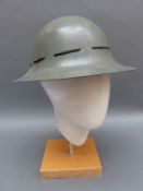 Two 1941 military helmets,
