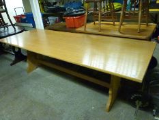 A contemporary light oak dining table,