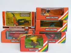 Six Britains model farm implements Vari-Spreader 9538, Forage Harvester 9542, Ploughs 9546,