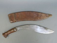 A WWII Gurkha kukri in sheath, marked to blade A.T.