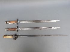 Two WWI bayonets, one marked Sanderson 1907 and also stamped 7 15, the other marked 1907,