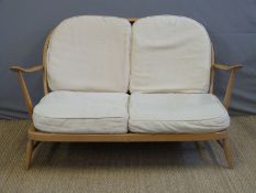 A light elm Ercol sofa,