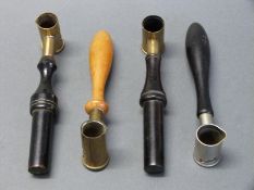 Four powder / shot measures all with turned wooden handles,