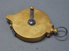 A brass rotary percussion cap dispenser with single suspension loop, 9.