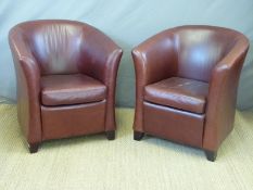 A pair of leather tub chairs