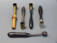 Four powder / shot measures three with turned wooden handles,
