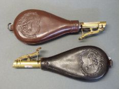 A pair of leather and brass shot flasks both with embossed decoration of dogs and single suspension