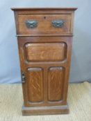 An early 20thC oak bedside cabinet with drawer and cupboard below,