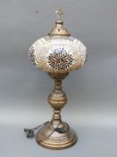 A decorative Moroccan style pedestal electric lamp,