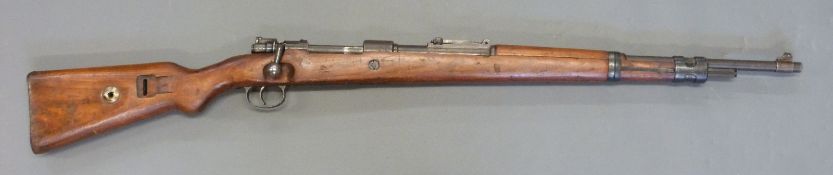 Deactivated Mauser K98 bolt action rifle with adjustable rear sight, leather sling,