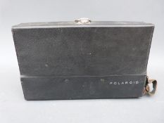 A cased Polaroid 103 camera with accessories