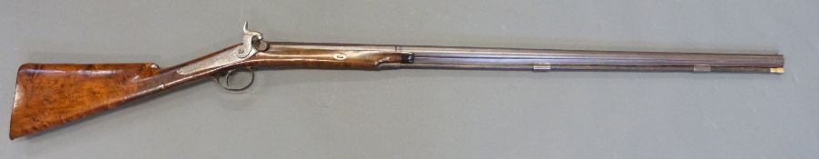 30 bore percussion hammer action gun with engraved lock and stylised dolphin hammer, chequered grip,