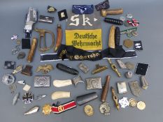 A quantity of military mainly reproduction handles, insignia, buckles etc.