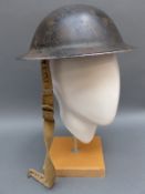 A WWII British military helmet stamped RO- CO AG 1943