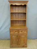 A slim pine dresser with plate rack above,