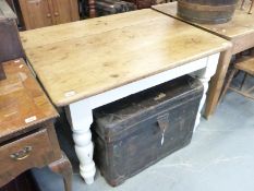 A pine kitchen table with turned wooden legs,