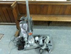 A Kirby vacuum cleaner with accessories and a Kirby Vacuette