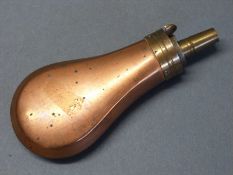 Copper and brass pistol powder flask with bevelled edges, 12cm long.