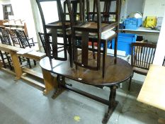 An oak extending table and four chairs,