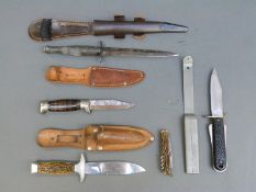 Fairbairn Sykes or similar fighting knife with ribbed grip in leather scabbard and three other