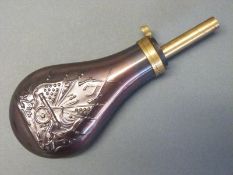 Copper and brass powder flask with embossed decoration of a cannon,