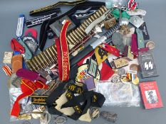 A quantity of mainly reproduction Nazi German insignia, dagger,