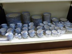 An extensive Royal Doulton dinner and tea service with pale blue and gold banded decoration,